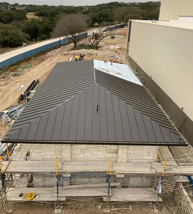 Metal roof new construction with scaffolding in West Point
